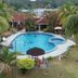 Hotel Seri Malaysia Mersing pool with palm trees and guests swimming in Mersing