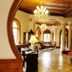 Moller Villa Hotel Shanghai ornate lobby with chandeliers, arched doorways and polished wood details