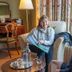 Lochinver Guest House Ayr lounge with guests seated by a lamp and table set with drinks