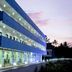 Blooming Paradise hotel in Thekkady at dusk, exterior with lit balconies and glass-fronted ground floor