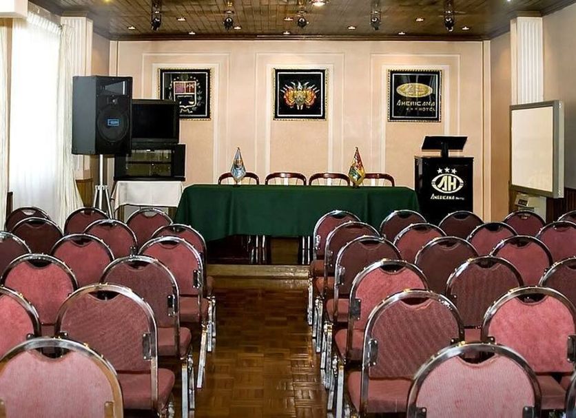 Americana Hotel in Cochabamba conference room with rows of chairs and a presentation table