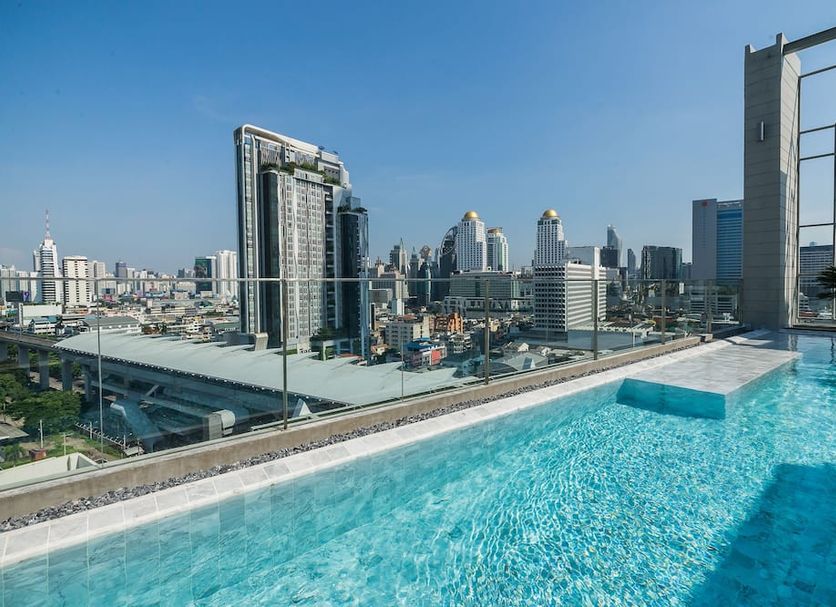 Rooftop infinity pool at Akara Hotel Bangkok with city skyline views in Bangkok
