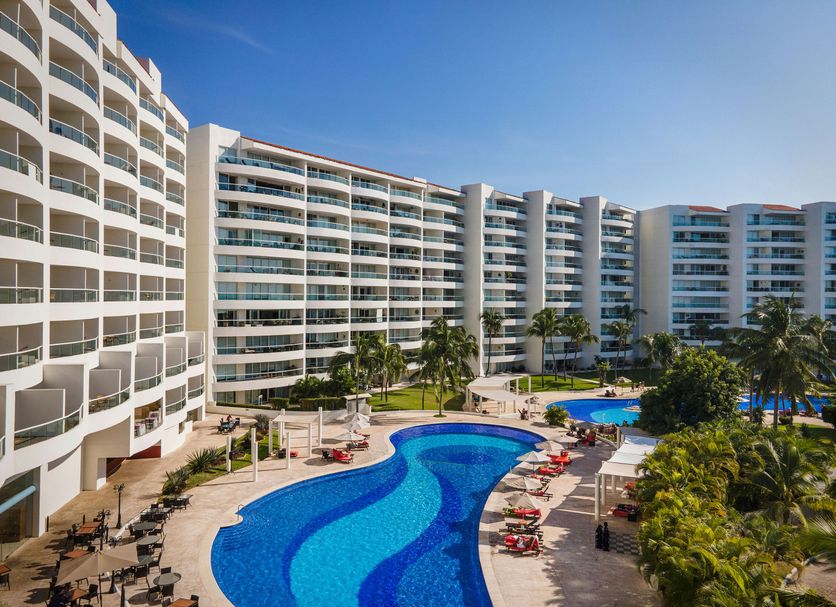 Fiesta Americana Riviera Nayarit in Nuevo Vallarta, oceanfront pool with loungers and palm trees