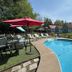 White Mountain Motel And Cottages in Lincoln: outdoor pool with lounge chairs and cottages
