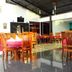 Grand Crown Hotel Anuradhapura restaurant with wooden tables and chairs in a bright dining area