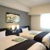 Hotel Route-Inn Utsunomiya Miyukicho guest room with two twin beds and a window