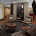 Towneplace Suites By Marriott Danville lobby seating area with chairs, tables, and wall map display.