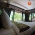 Lipe Sunset Beach Resort room with bed and large windows overlooking greenery in Ko Lipe
