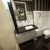 Amérian Executive Córdoba bathroom with sink, toilet, bidet, and wall-mounted hair dryer in Cordoba