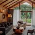 Aman Rosa Alpina in Badia/Abtei living room with mountain and forest view through glass doors
