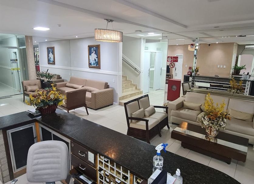 Faixa Hotel lobby in Vitória da Conquista with seating area, front desk, and staircase