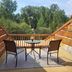 Buffalopeaks Lodge in Buena Vista balcony with two chairs, round table, and forest view