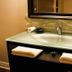 Gatekeeper's Retreat Niagara-on-the-Lake bathroom vanity with glass sink, mirror and folded towels