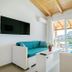 Palapart Gikas Suites And Studios in Gouvia with teal sofas, balcony doors, and a pool view