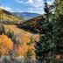 High Desert Inn in Salina with autumn trees framing a scenic mountain valley and blue sky