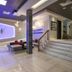 Le Noranda Hotel & Spa lobby in Rouyn-Noranda with lit sign, staircase and seating area