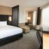 Residence Inn by Marriott Grand Rapids Downtown guest room with king bed, chaise lounge and city-view windows