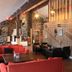 Hafjell Hotell in Øyer (Hafjell) lounge with red sofas, stone walls, and ski-themed decor