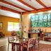 Hotel Montaña Monteverde in Santa Elena lobby with seating, dining table, and large forest mural