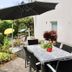 Hotel Garni Niedernhausen in Niedernhausen outdoor terrace with dining table, chairs and umbrella