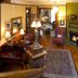 Beaufort House Inn in Asheville living room with fireplace, dining table and wood floors