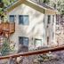 Lower Unit-Yosemite Woods-Inside Yosemite in Yosemite West, two-story cabin with exterior stairs in forest setting