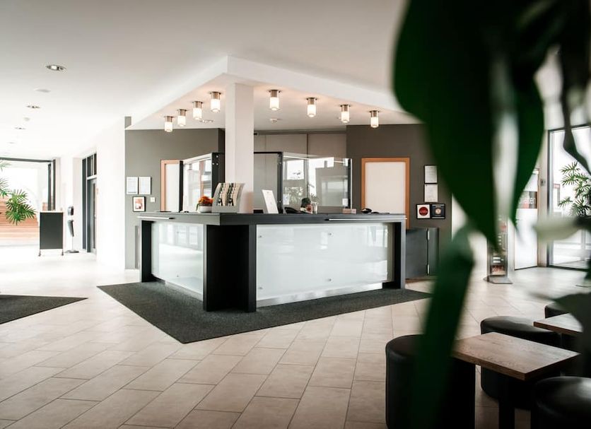 Hotel & Restaurant Ochsen Merklingen lobby with front desk, tiled floor and seating area in Merklingen