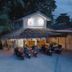 Blue Turtle Hotel Samui in Ko Samui at dusk, with a thatched entrance and parked scooters