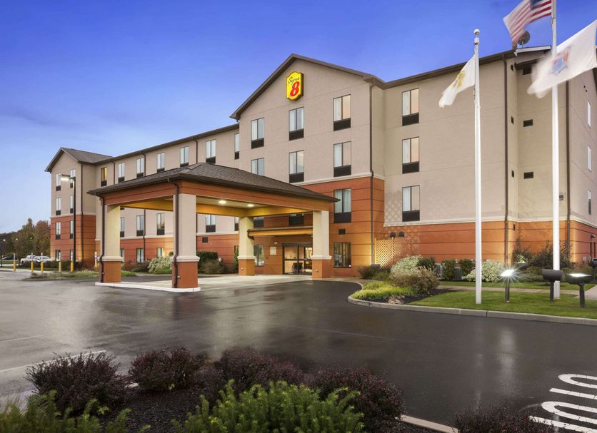Super 8 by Wyndham Pennsville/Wilmington exterior in Pennsville with covered entrance and flags