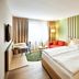 Hotel Zugbrücke Grenzau room in Hohr Grenzhausen with twin bed, sofa, desk and balcony view