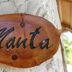 Blue World Dharavandhoo sign reading Manta on wooden plaque in Dharavandhoo