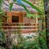 Bamboo Bungalow Resthouse Boracay bamboo bungalow with thatched roof and balcony in tropical greenery