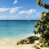 Sapphire Beach Club Resort in Simpson Bay with a turquoise beach, calm ocean, and rocky shoreline