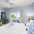 Harbour House At The Inn room in Fort Myers Beach with balcony view, TV, and nautical bedding