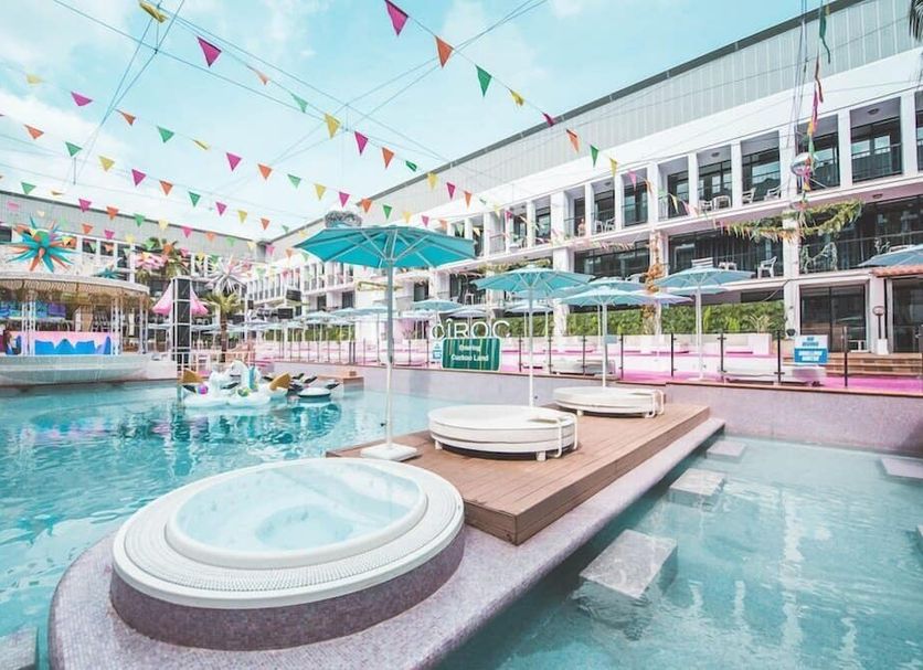 Ibiza Rocks Hotel in Sant Antoni de Portmany with poolside hot tubs and colorful bunting over the courtyard pool.