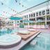 Ibiza Rocks Hotel in Sant Antoni de Portmany with poolside hot tubs and colorful bunting over the courtyard pool.