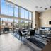 Comfort Inn Aikens Center Martinsburg lobby with seating area, large windows, and wall-mounted TV