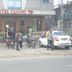 Hotel cloud 9 in Madhubani street view with parked cars, motorcycles, and people outside the entrance