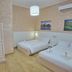 Bel Sole Civitavecchia hotel room with two beds, wardrobe, wall art and air conditioning