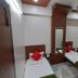 Hotel City Palace Nashik twin room with two single beds, mirror, curtains, and seating area