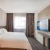 Hanting Hotel Zibo Jinjing Avenue Municipal Government guest room with bed, window and wall-mounted TV in Zibo