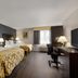 Baymont by Wyndham Branford/New Haven guest room with two beds, desk, TV and window view in Branford