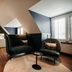 Hotel & Spa Savarin in Rijswijk guest room with seating area, bed, and skylit sloped ceiling