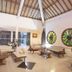 Mirah Hotel & Resort Banyuwangi lobby lounge with seating, high ceiling and decorative round windows