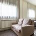 Residencia Universitaria Resa Los Abedules in Pamplona with twin beds, armchair and bright windows
