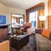 Homewood Suites by Hilton Lynnwood Seattle Everett, WA living room with TV, sofa, armchair and bedroom doorway