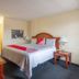 OYO Hotel San Antonio Lackland Near Seaworld room with king bed, nightstands, desk and lamp in San Antonio