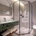 24k International Hotel People's Square bathroom in Shanghai with glass shower, wall-mounted sink and toilet