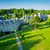 Ashdown Park Hotel & Country Club in East Grinstead, aerial view of the stone manor and manicured lawns