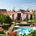 Le Manoir de Gressy in Gressy with garden and outdoor pool beside red-roofed buildings